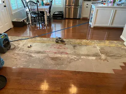 Wet flooring pulled back during a water damage dry-out in Cypress, TX
