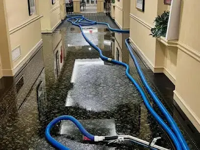 Standing water being extracted from a floor in a Cypress, TX home
