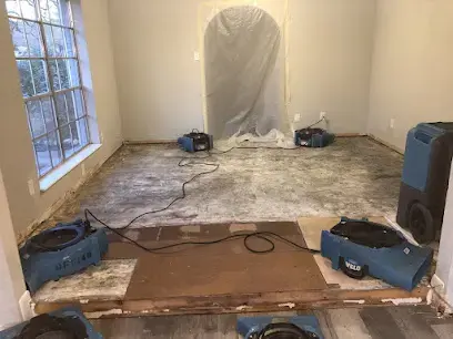 Drying equipment set up in a water-damaged room in Cypress, TX