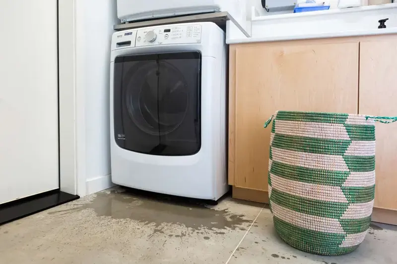 Water on the floor from a washing machine leak in Cypress, TX