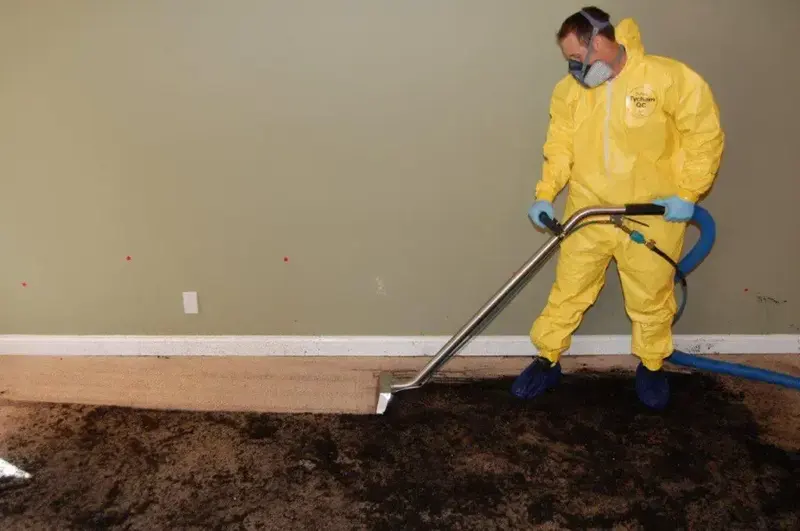 Technician in protective gear on a sewage backup cleanup in Cypress, TX