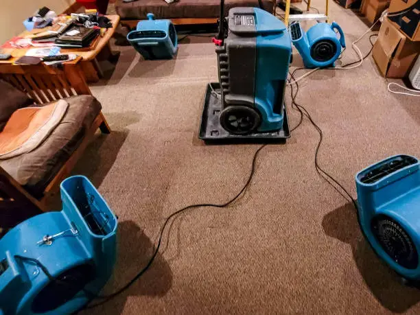 Air movers and a dehumidifier drying a room in Cypress, TX