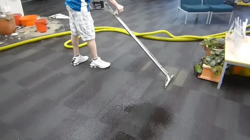 Extraction wand pulling standing water off a floor in a Cypress, TX home